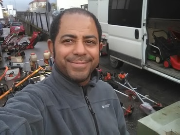 Danny mit Rasenmähern, Motorsensen usw. für den Container
